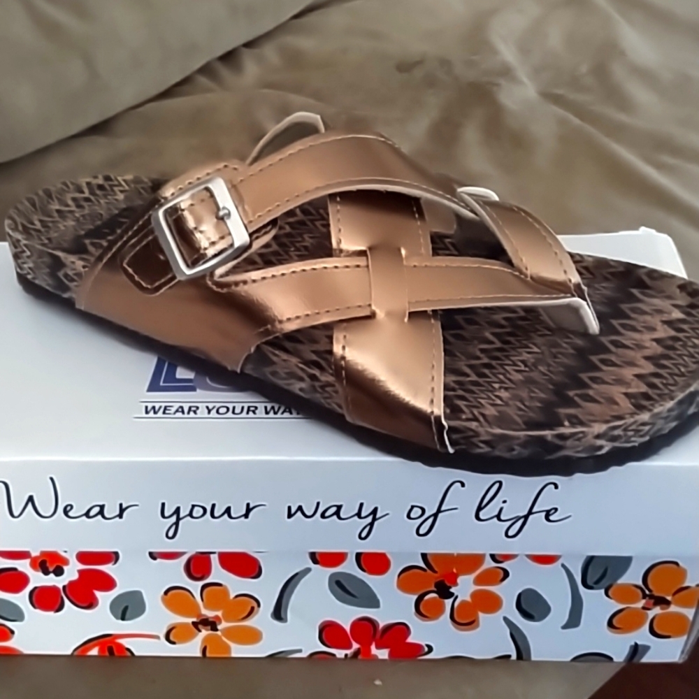One pair of brand new bronze Muk Luks sandals. 11m